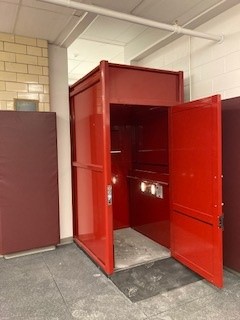 Big red commercial wheelchair lift by garaventa at a library